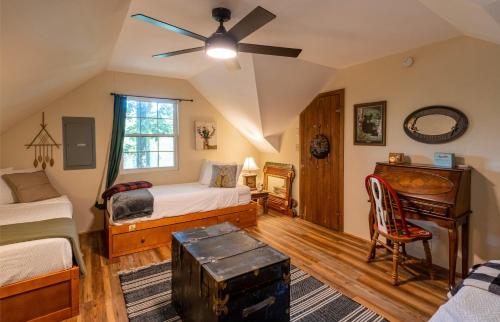 a bedroom with two beds and a ceiling fan at stayNantahala - Smoky Mountain Cabins in Aquone