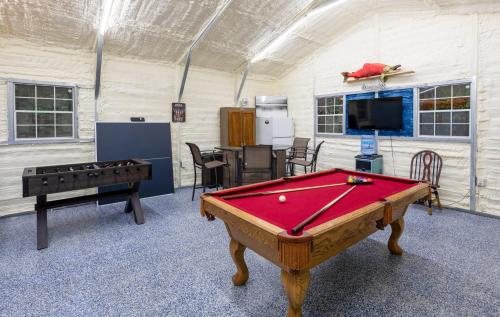 a room with a pool table and a tv at stayNantahala - Smoky Mountain Cabins in Aquone