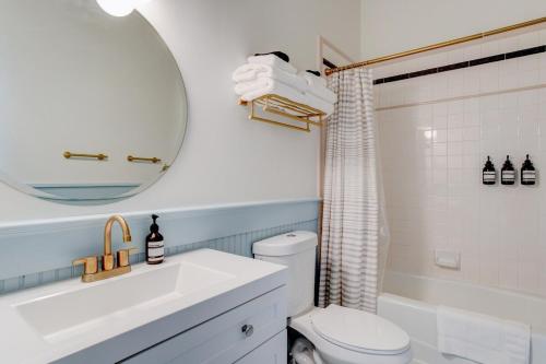 uma casa de banho com um lavatório, um WC e um espelho. em Suite 3 Historic Art City Inn em Springville
