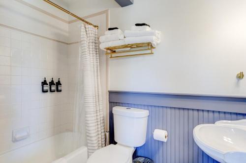 a bathroom with a white toilet and a sink at Suite 11 Historic Art City Inn in Springville