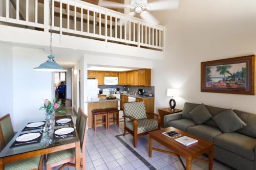 a living room with a couch and a table at Maui Schooner Resort in Kihei