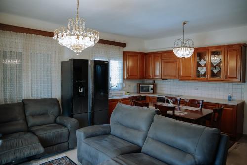a living room with a couch and a kitchen at Friendly Flat 5 in Edessa