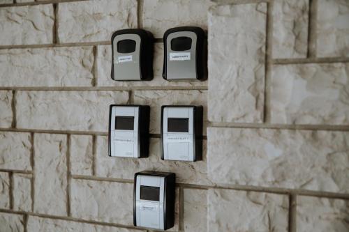 a brick wall with three cell phones on it at Friendly Flat 5 in Edessa