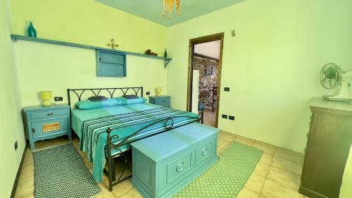 a bedroom with a bed with blue furniture and a doorway at Ca' del Bosco in Alassio