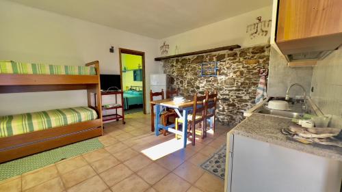 a kitchen with a sink and a table in a room at Ca' del Bosco in Alassio