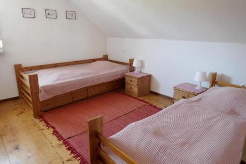 um quarto com 2 camas e um tapete vermelho em Ferienhaus Buschle em Tettnang