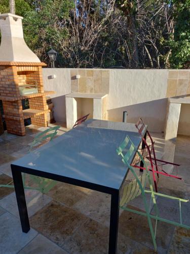 a blue ping pong table in front of a bench at Gîte de Fanny du Moulin de Tartay en Avignon in Avignon