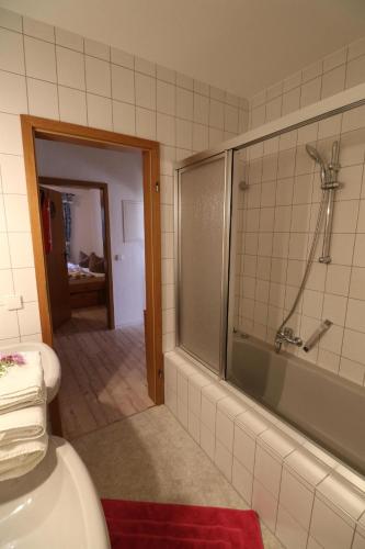 a bathroom with a shower and a bath tub at Ferienwohnung Leibelt in Füssen