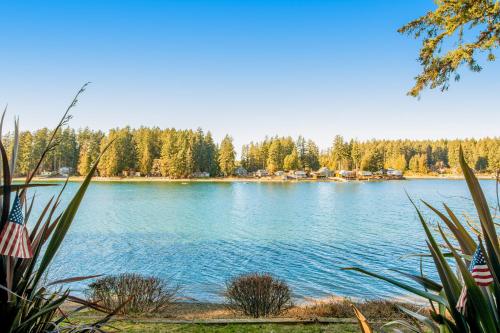 a view of a lake with trees in the background at Treasure Island Escape in Allyn
