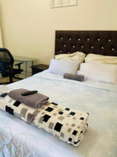 a bed with a black and white blanket on it at Crystal Mini Pozz Palace in Johannesburg