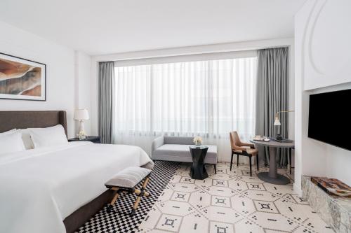 a hotel room with a bed and a large window at Fairmont La Marina Rabat Sale Hotel in Rabat