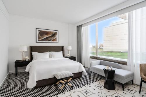 a bedroom with a bed and a large window at Fairmont La Marina Rabat Sale Hotel in Rabat
