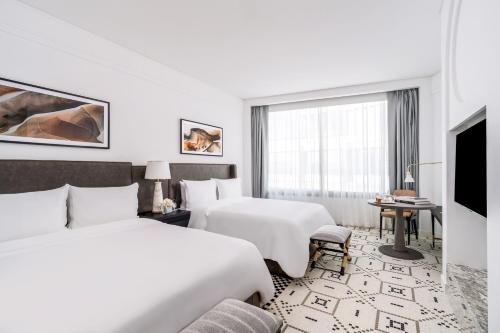 a hotel room with two beds and a tv at Fairmont La Marina Rabat Sale Hotel in Rabat
