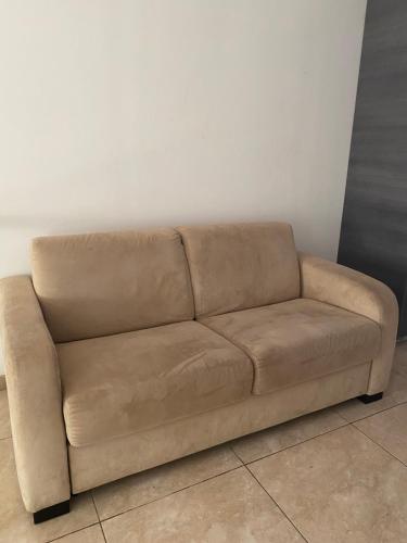 a brown couch sitting in a room at Alexia Hotel Apartments in Ayia Napa