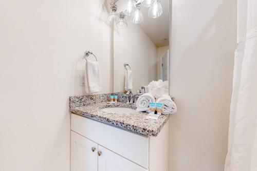 a bathroom sink with a granite counter top at Rehoboth Beach House --- 20494 Coastal Highway Unit #3 in Rehoboth Beach