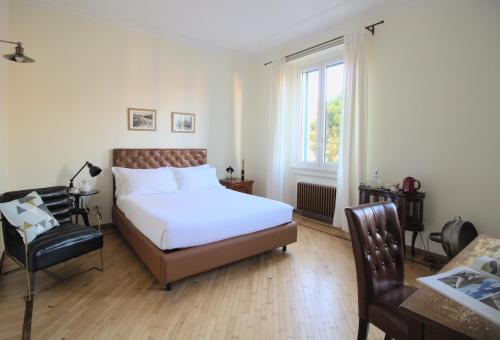 a bedroom with a bed and a chair and a window at Porta Tosa Boutique in Milan