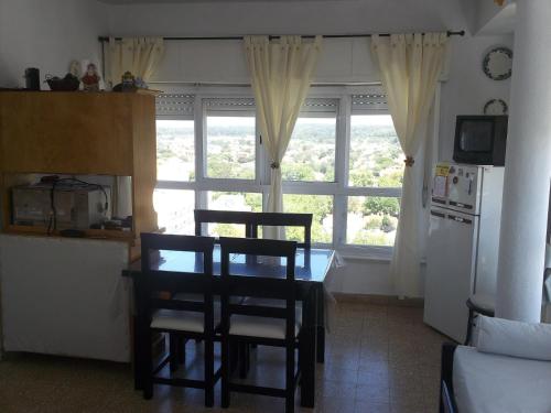 cocina con mesa y sillas frente a una ventana en Mono ambiente miramar en Miramar