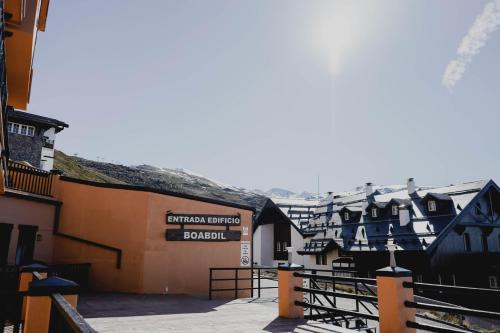 a group of buildings with a sign that reads emerald city guest house at Apartamentos Boabdil in Sierra Nevada