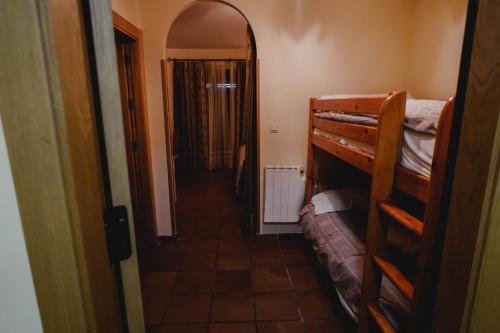 a hallway leading to a room with bunk beds at Apartamentos Boabdil in Sierra Nevada