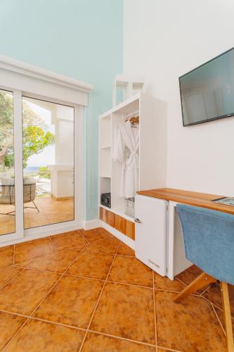 a home office with a desk and a window at Blue Roatan Resort in West Bay