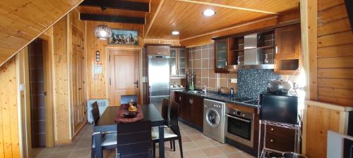 a kitchen with wooden cabinets and a stove top oven at Apartamentos Boabdil in Sierra Nevada
