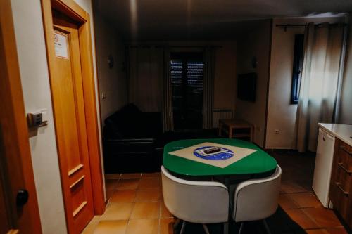 a kitchen with a table in the middle of a room at Apartamentos Boabdil in Sierra Nevada