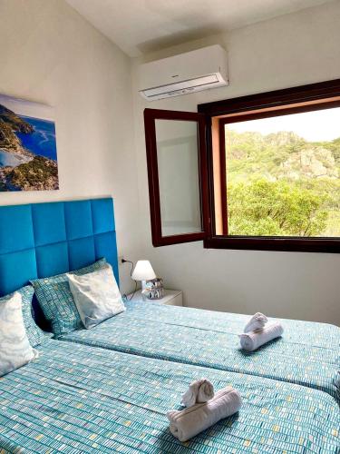 a bedroom with two beds with towels on them at Casa Paradiso in Costa Paradiso