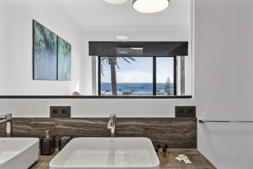 a bathroom with a sink and a large window at Villa Atlantico - Villasexperience in Arrecife