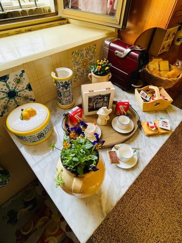 a kitchen counter with a table with food on it at La Bouganville B&B in Acconia
