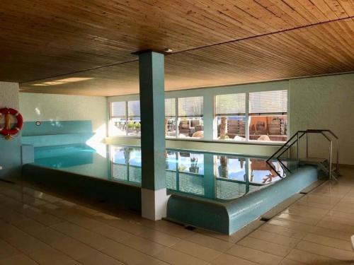 a swimming pool in the middle of a building at Wohnung mit herrlichem Blick auf den Pilatus in Weggis