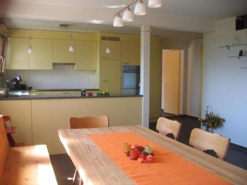 a kitchen with a wooden table with fruit on it at Ferienhaus Staudenhof Naturnah und idylisch in Präz