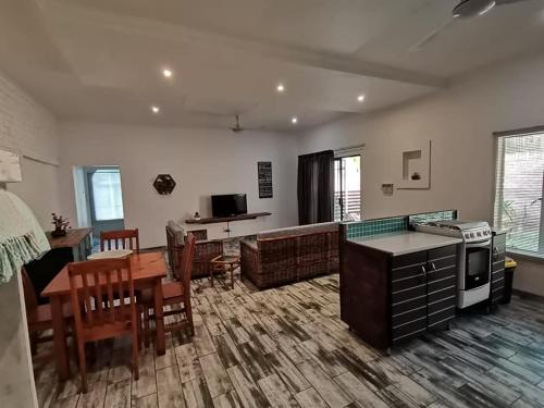 a living room with a kitchen and a dining room at 34 Hornbill Street in St Lucia