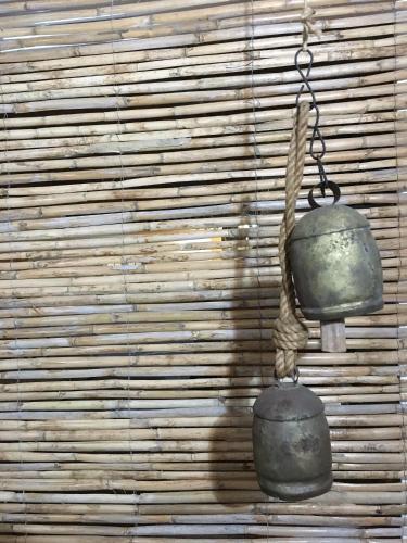 a pair of bells hanging on a wall at Varandas do Vale Furnazinhas in Castro Marim