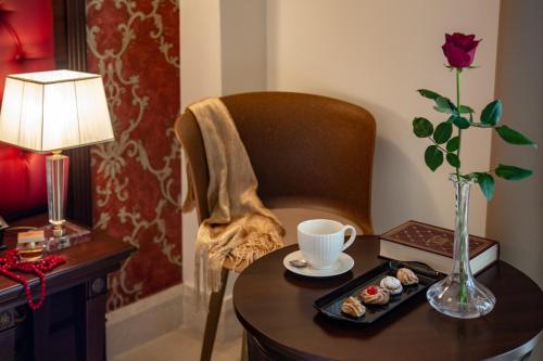 a table with a plate of sushi and a cup of coffee at La Paloma Blanca Hotel in Sciacca