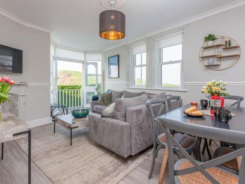 a living room with a couch and a table at 2TheVilla - Great views, 3 bedrooms, parking, central location in Ilfracombe