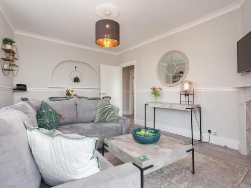 a living room with a couch and a table at 2TheVilla - Great views, 3 bedrooms, parking, central location in Ilfracombe