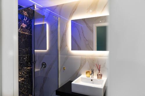 a bathroom with a sink and a shower at La Lepre felice-bovio in Naples