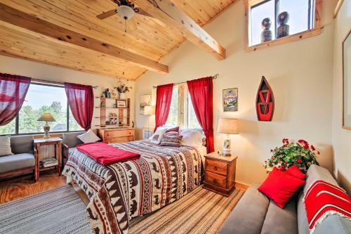 a bedroom with a bed and a couch at Idyllic Dolores Cabin with Fire Pit and Lake Views! in Dolores