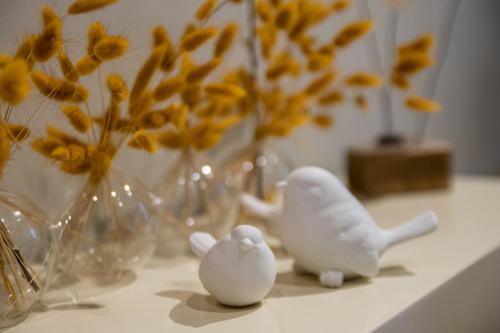 two white figurines sitting on a counter with vases at Made in Lourmarin in Lourmarin