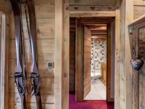 a room with skis hanging on the wall at Appartement Saint-Jean-de-Belleville, 4 pièces, 8 personnes - FR-1-570-29 in Saint-Martin-de-Belleville