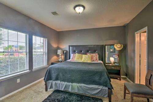 a bedroom with a bed and a chair and windows at City Retreat- NRG & Downtown and Medical Center in Houston