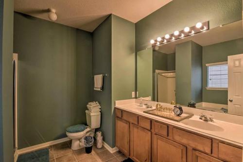 a bathroom with a sink and a toilet and a mirror at City Retreat- NRG & Downtown and Medical Center in Houston