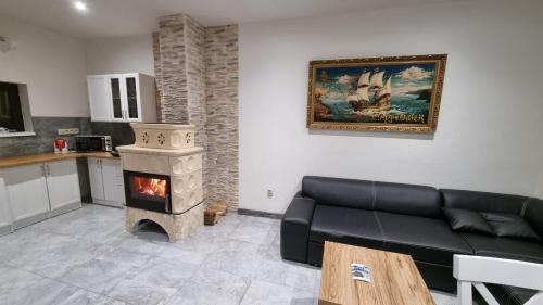 a living room with a couch and a stove at Apartmány Sebastián in Pribylina