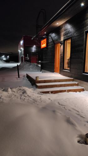 a group of steps in the snow in front of a building at Black Hotel in Kempele