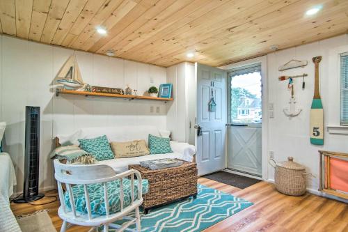 a living room with a couch and a table at Walk to Beach Bright and Cozy Cape Cod Studio! in Dennis Port