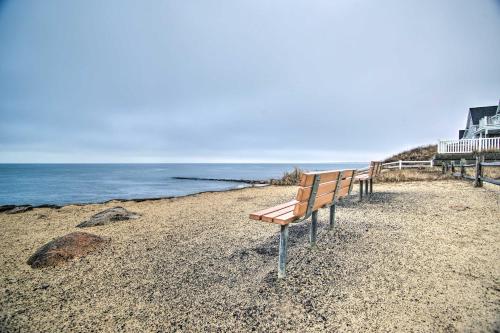 a bench sitting on a beach near the ocean at Walk to Beach Bright and Cozy Cape Cod Studio! in Dennis Port
