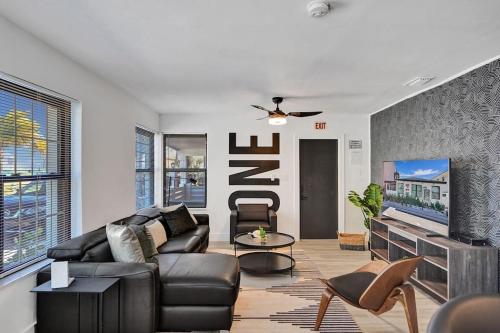 a living room with a leather couch and a fireplace at Hollywood Apartments Host by BeeNomad in Hollywood