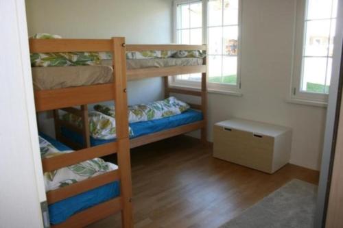 Zimmer mit 3 Etagenbetten und einem Fenster in der Unterkunft Bädli im Munzenriet in Wildhaus