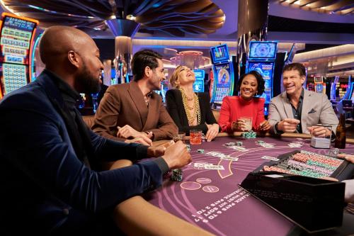 a group of people sitting at a poker table in a casino at SAHARA Las Vegas in Las Vegas