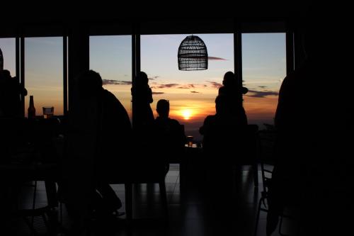 a group of people sitting at a table watching the sunset at Ocotea Boutique Hotel in Monteverde Costa Rica